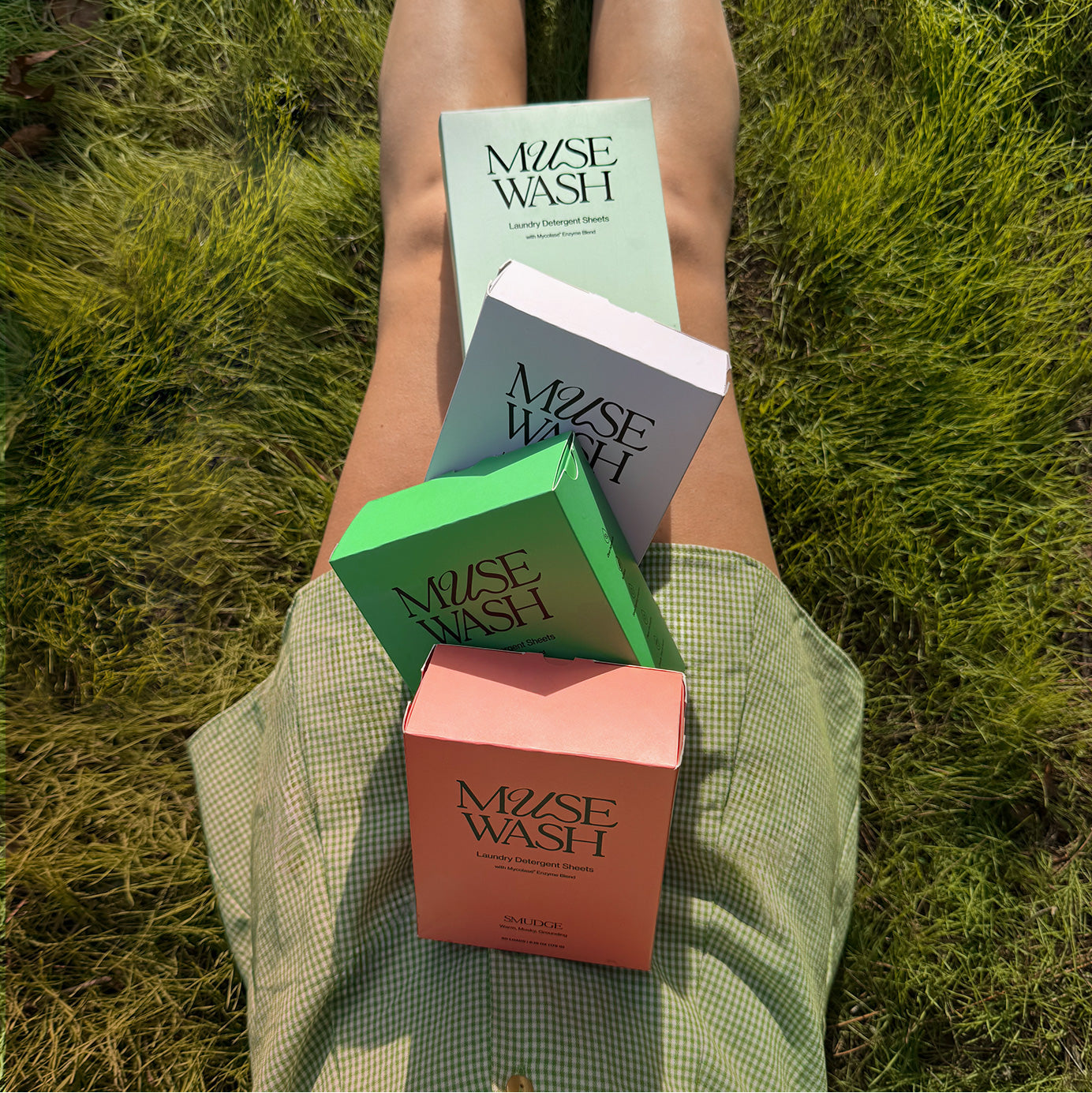 Biodegradable laundry sheets made with plant-based ingredients in colorful compostable packaging